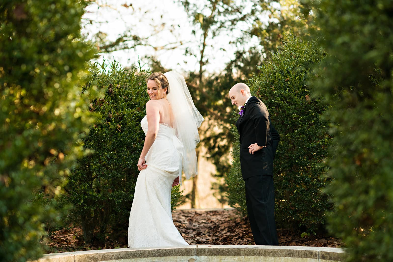 A bride and groom in a garden at their wedding